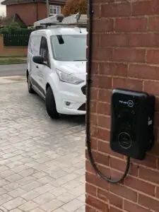 installed electric vehicle charger on a brick wall